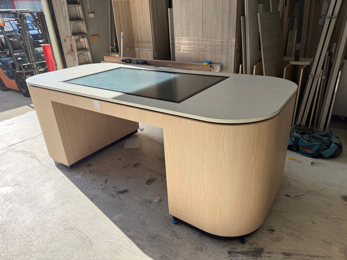 Master artisan measuring high-quality walnut slab with brass tools in a sunlit workshop